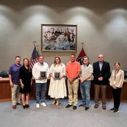 Tim, City of Goodlettsville Commissioners, and the City Recorder recognizing DJ Johnson and Hannah Johnson with SageGuard Finanancial on their sponsorship of veteran banners