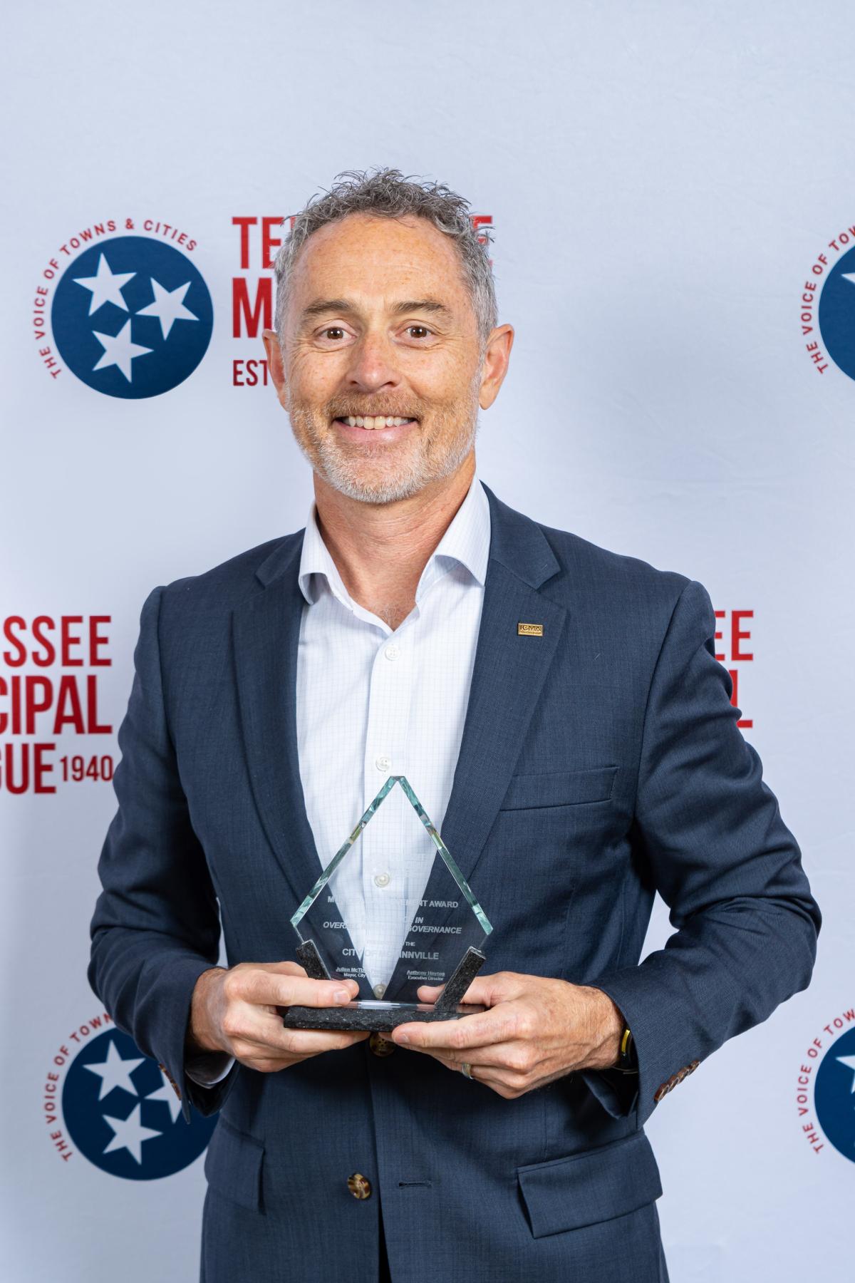 McMinnville City Administrator Nolan Ming accepts the award for Excellence in Overall Municipal Governance. 